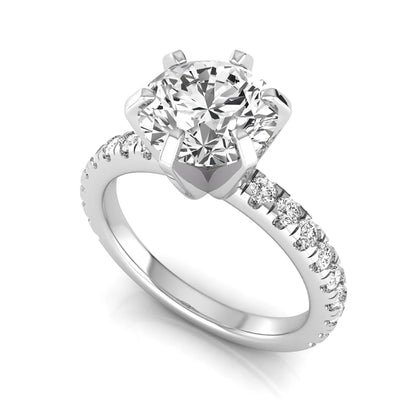 Round cut lab grown diamond engagement ring featuring a six-prong solitaire setting with a pavé accent band and polished white gold tone finish.