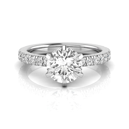 Round cut lab grown diamond engagement ring featuring a six-prong solitaire setting with a pavé accent band and polished white gold tone finish.