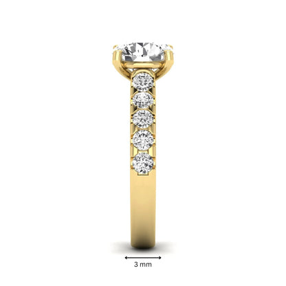 Round solitaire accent lab grown diamond engagement ring featuring a 2.50 carat round brilliant IGI certified center diamond with round accent diamonds on a yellow gold band.