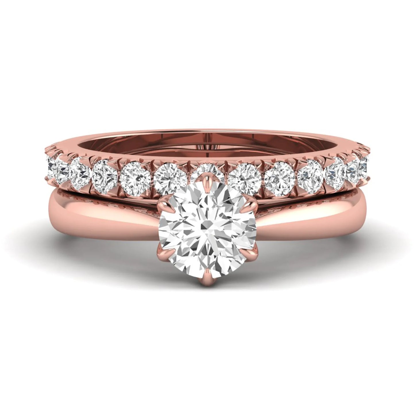 Round cut lab grown diamond solitaire bridal ring set featuring a six-prong engagement ring with a matching shared-prong round diamond wedding band in rose gold tone design.