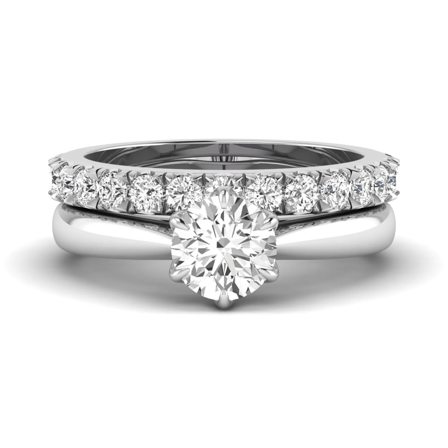 Round cut lab grown diamond solitaire bridal ring set featuring a six-prong engagement ring with a matching shared-prong round diamond wedding band in white gold tone design.