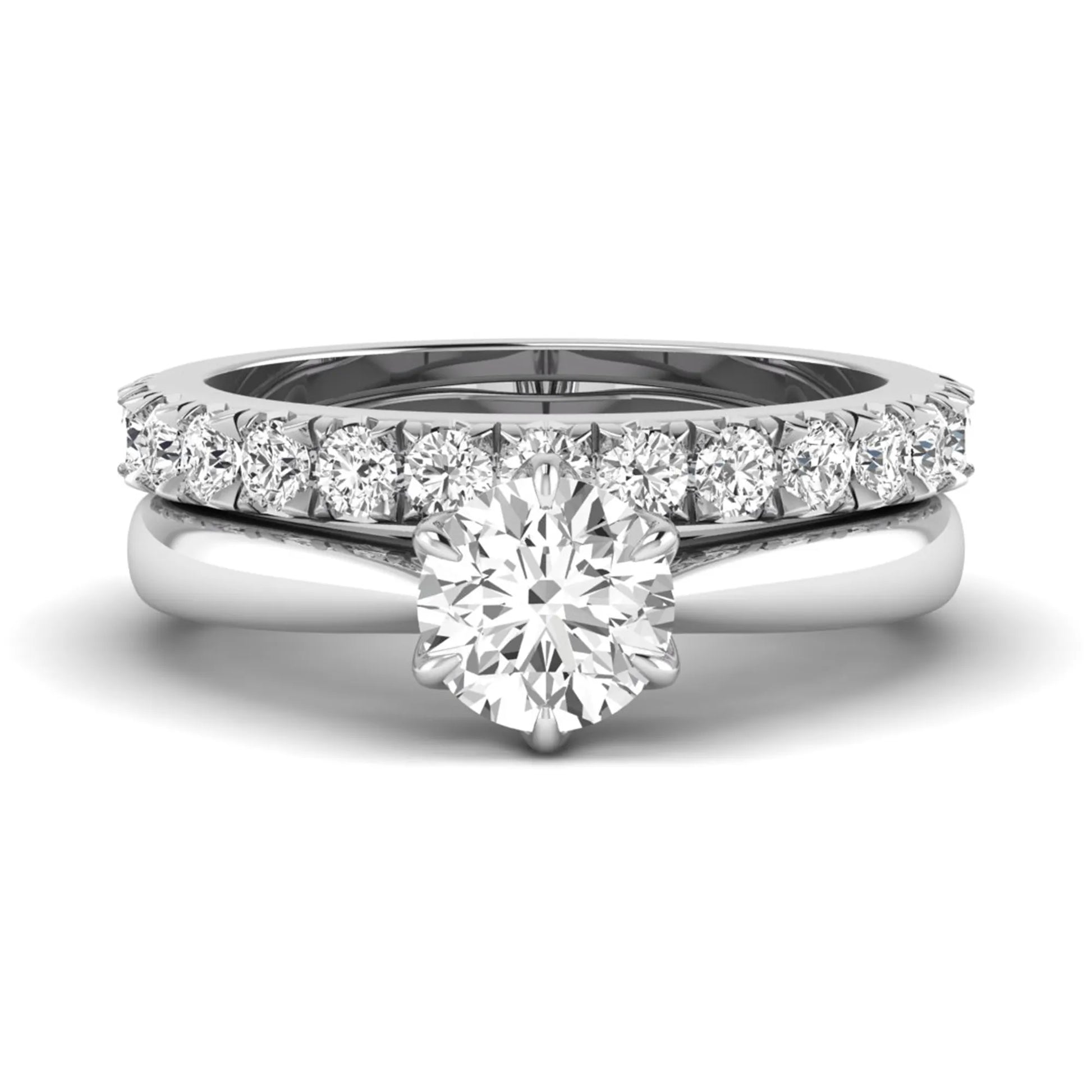 Round cut lab grown diamond solitaire bridal ring set featuring a six-prong engagement ring with a matching shared-prong round diamond wedding band in white gold tone design.