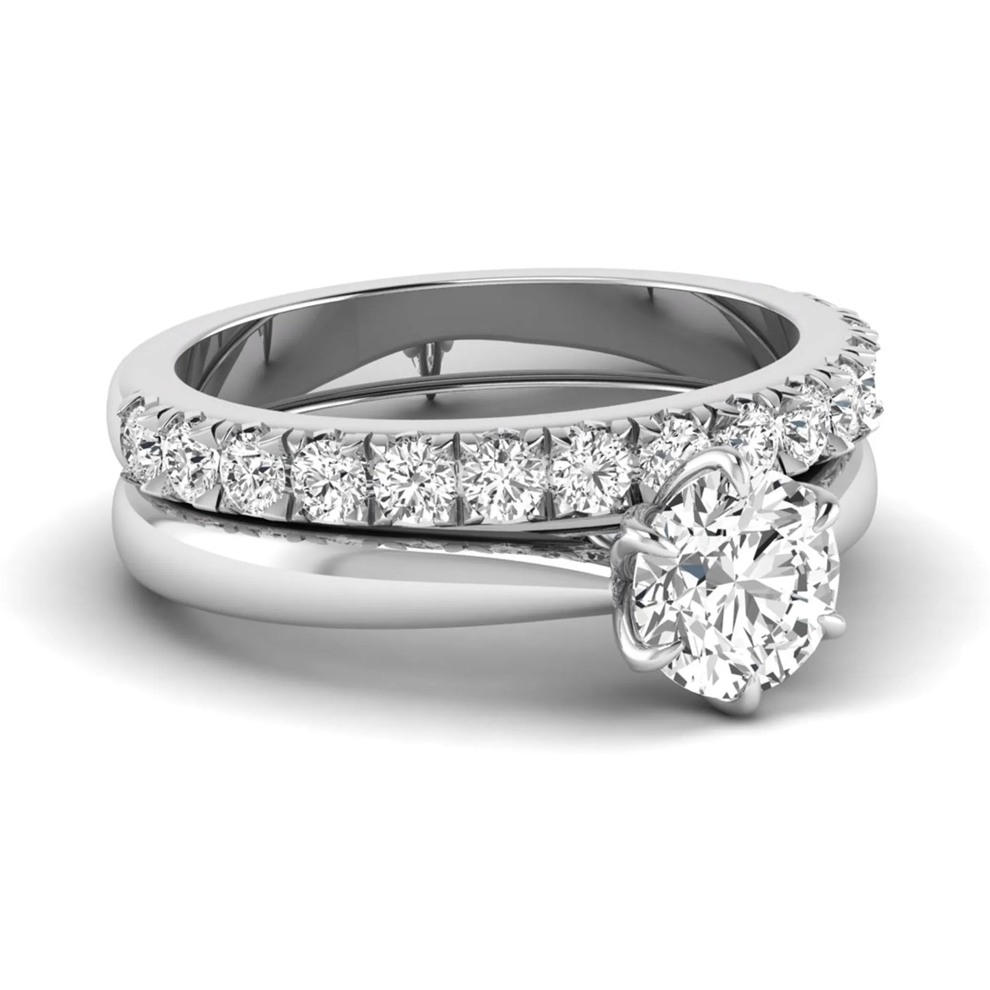 Round cut lab grown diamond solitaire bridal ring set featuring a six-prong engagement ring with a matching shared-prong round diamond wedding band in white gold tone design.