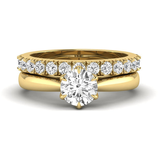Round cut lab grown diamond solitaire bridal ring set featuring a six-prong engagement ring with a matching shared-prong round diamond wedding band in yellow gold tone design.