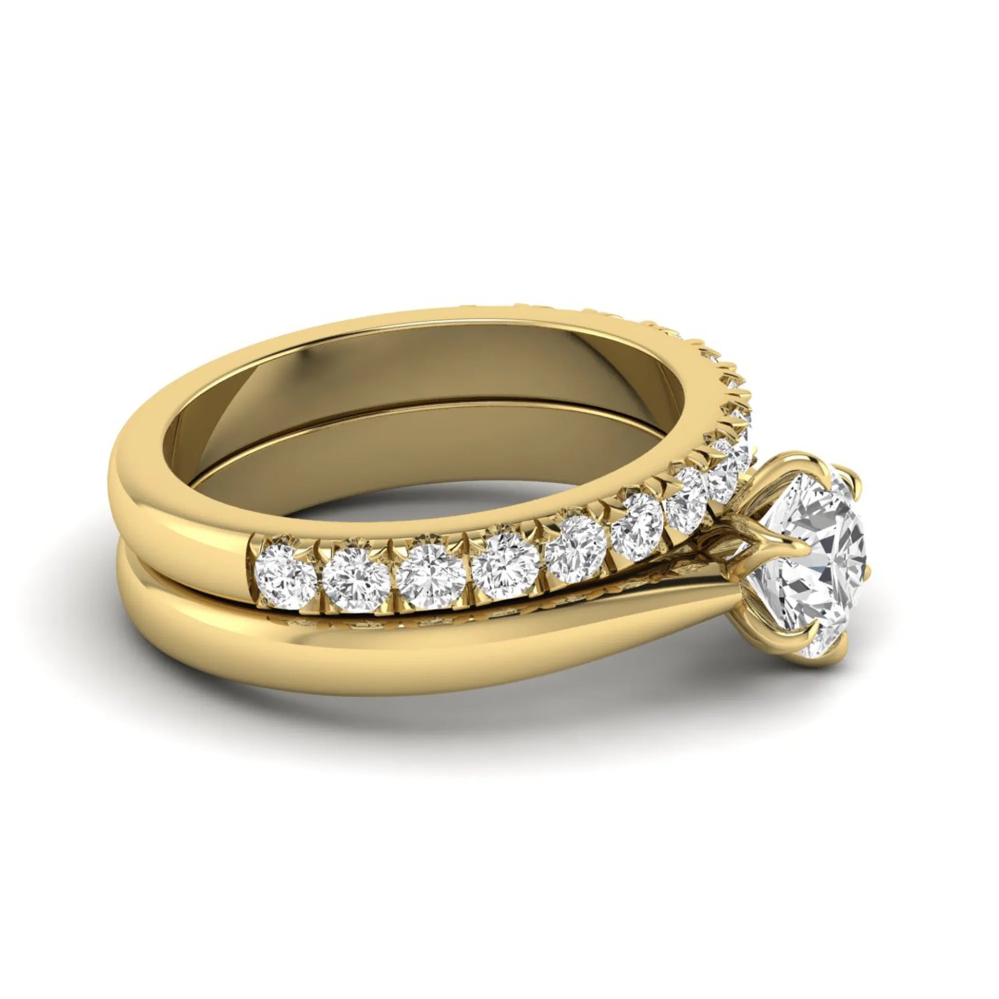 Round cut lab grown diamond solitaire bridal ring set featuring a six-prong engagement ring with a matching shared-prong round diamond wedding band in yellow gold tone design.