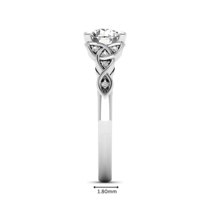Round cut lab grown diamond solitaire engagement ring featuring a four-prong center diamond with an intricate Celtic knot-inspired band and round accent diamonds in a white gold finish.