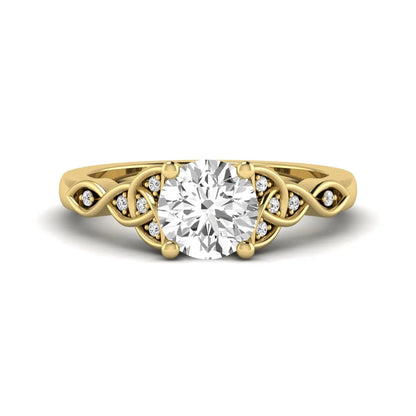 Round cut lab grown diamond solitaire engagement ring featuring a four-prong center diamond with an intricate Celtic knot-inspired band and round accent diamonds in a yellow gold finish.