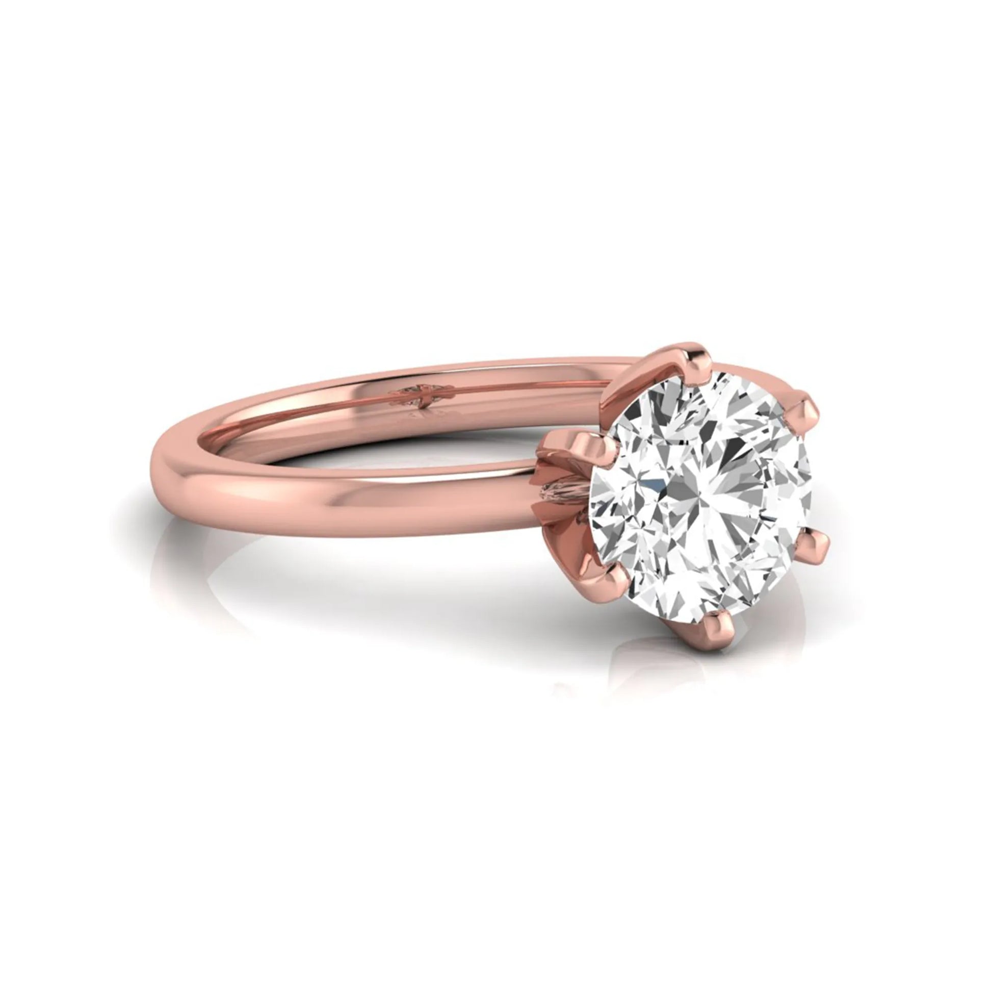 Round cut lab grown diamond solitaire engagement ring with six prong setting and rose gold metal tone.