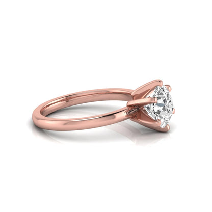 Round cut lab grown diamond solitaire engagement ring with six prong setting and rose gold metal tone.