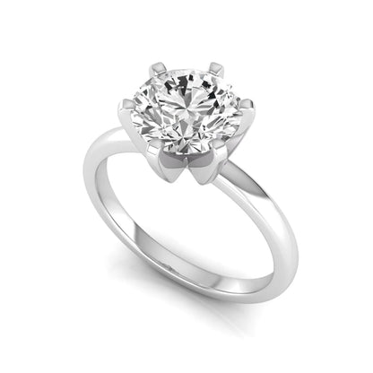 Round cut lab grown diamond solitaire engagement ring with six prong setting and white gold metal tone.