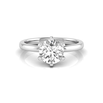 Round cut lab grown diamond solitaire engagement ring with six prong setting and white gold metal tone.