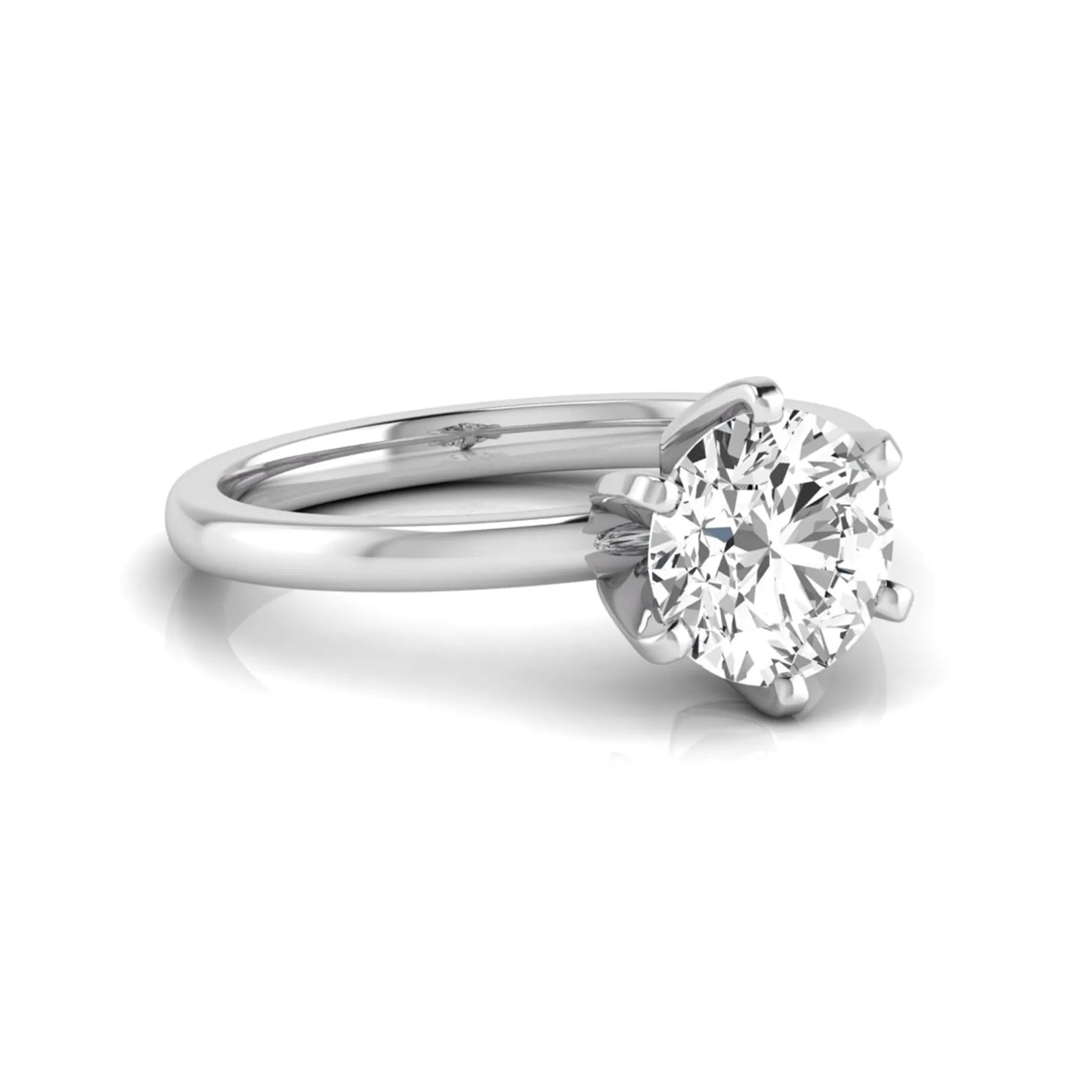 Round cut lab grown diamond solitaire engagement ring with six prong setting and white gold metal tone.