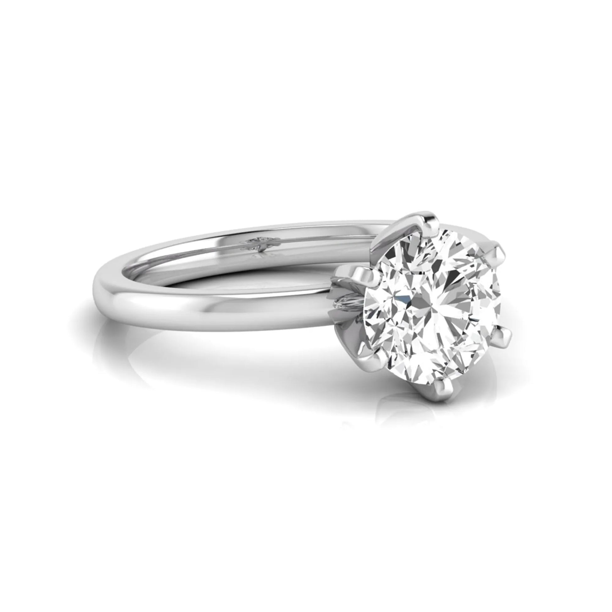 Round cut lab grown diamond solitaire engagement ring with six prong setting and white gold metal tone.