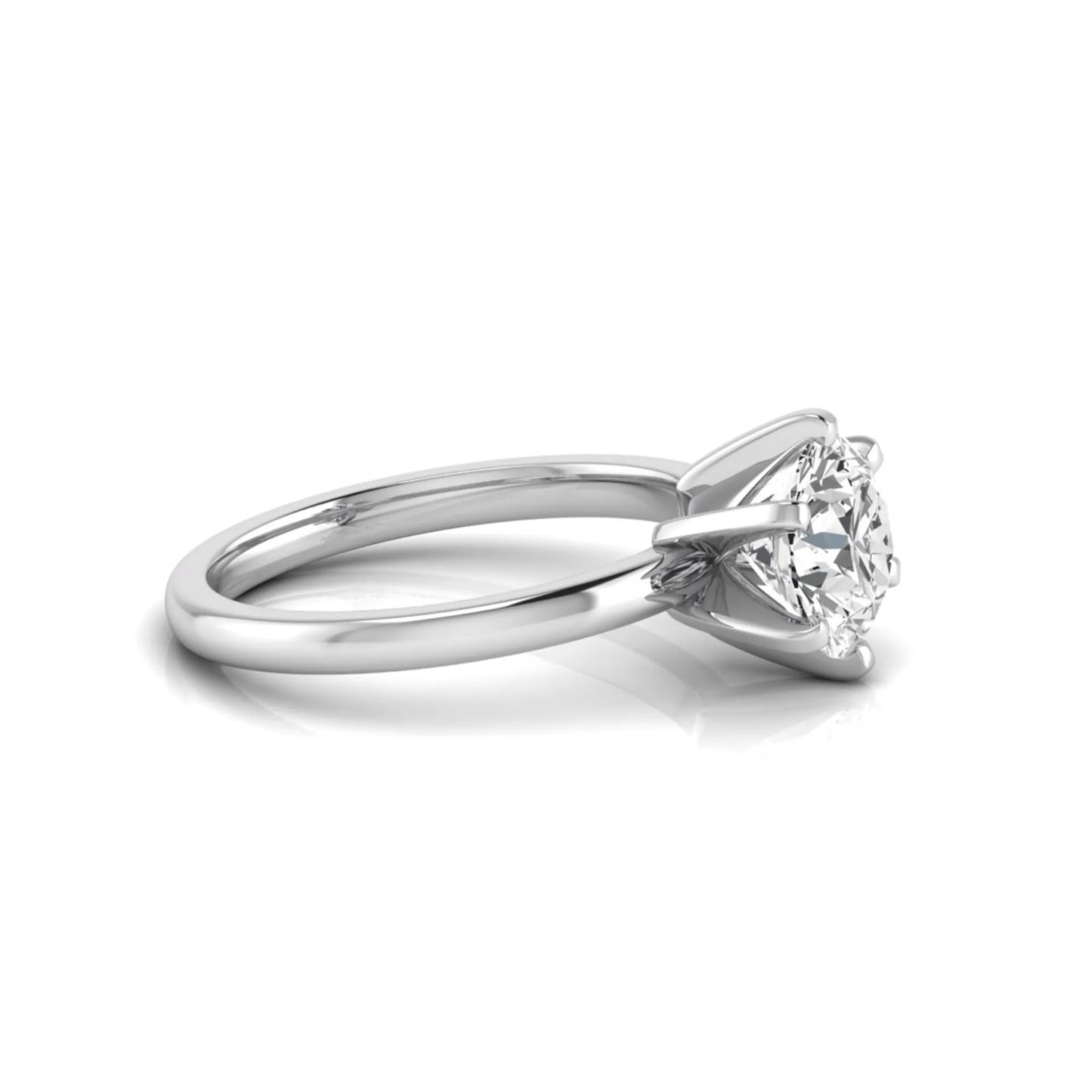 Round cut lab grown diamond solitaire engagement ring with six prong setting and white gold metal tone.