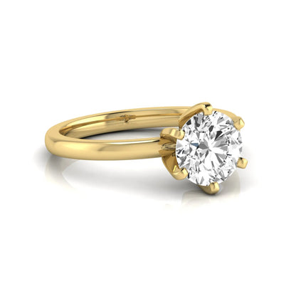 Round cut lab grown diamond solitaire engagement ring with six prong setting and yellow gold metal tone.