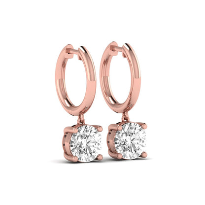 Round cut lab grown diamond solitaire huggie drop earrings featuring a four-prong basket setting, hinged snap closure, and rose gold tone design.