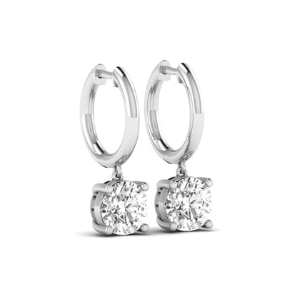 Round cut lab grown diamond solitaire huggie drop earrings featuring a four-prong basket setting, hinged snap closure, and white gold tone design.