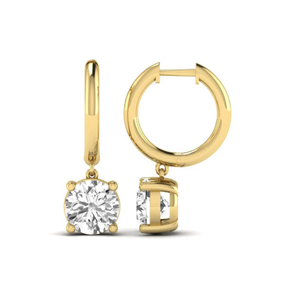 Round cut lab grown diamond solitaire huggie drop earrings featuring a four-prong basket setting, hinged snap closure, and yellow gold tone design.