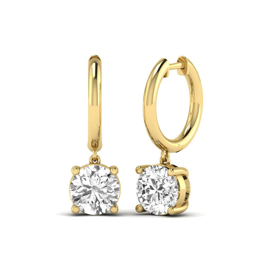 Round cut lab grown diamond solitaire huggie drop earrings featuring a four-prong basket setting, hinged snap closure, and yellow gold tone design.