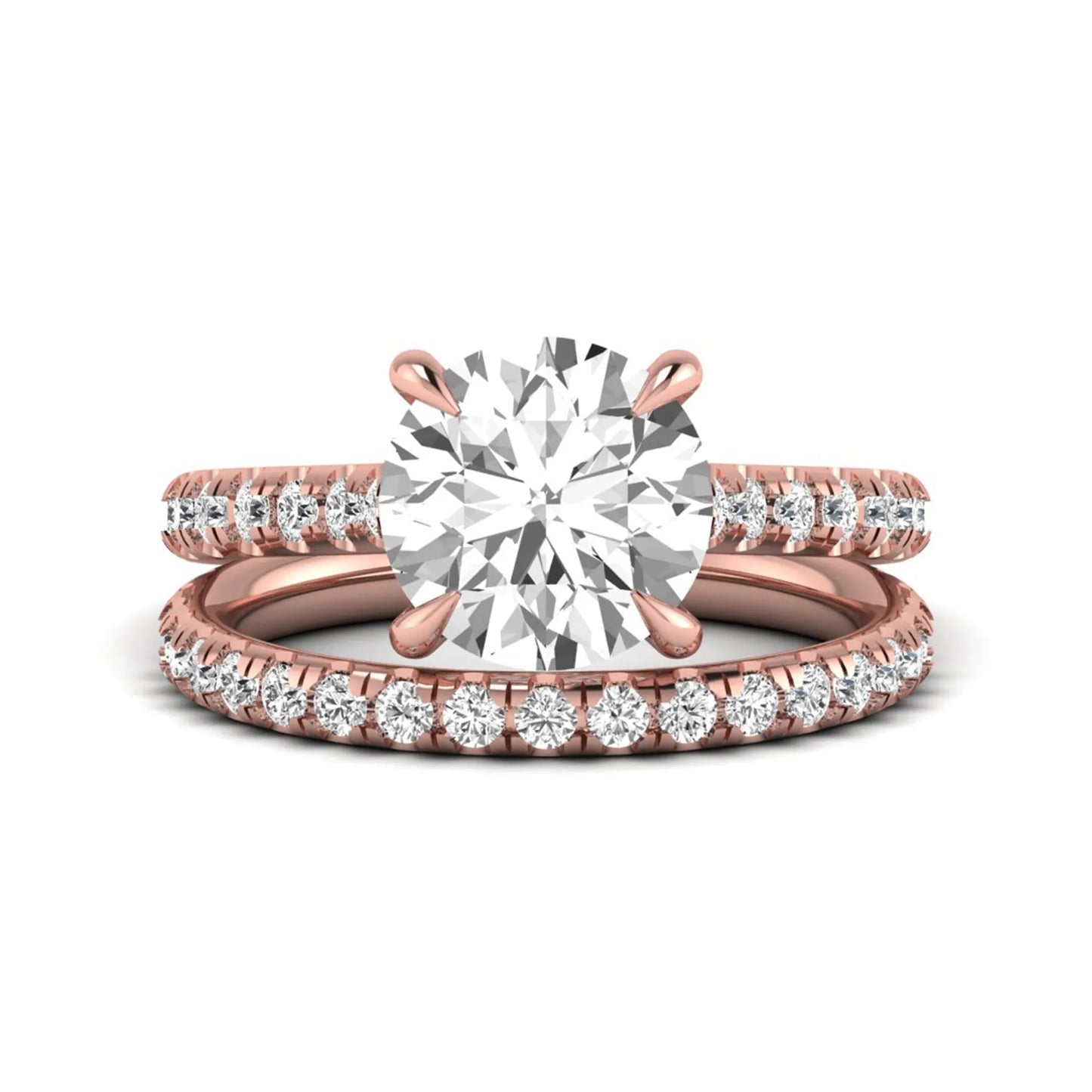 Round cut lab grown diamond bridal ring set featuring a four-prong solitaire center diamond with pavé-set engagement ring and matching pavé wedding band in a rose gold finish.