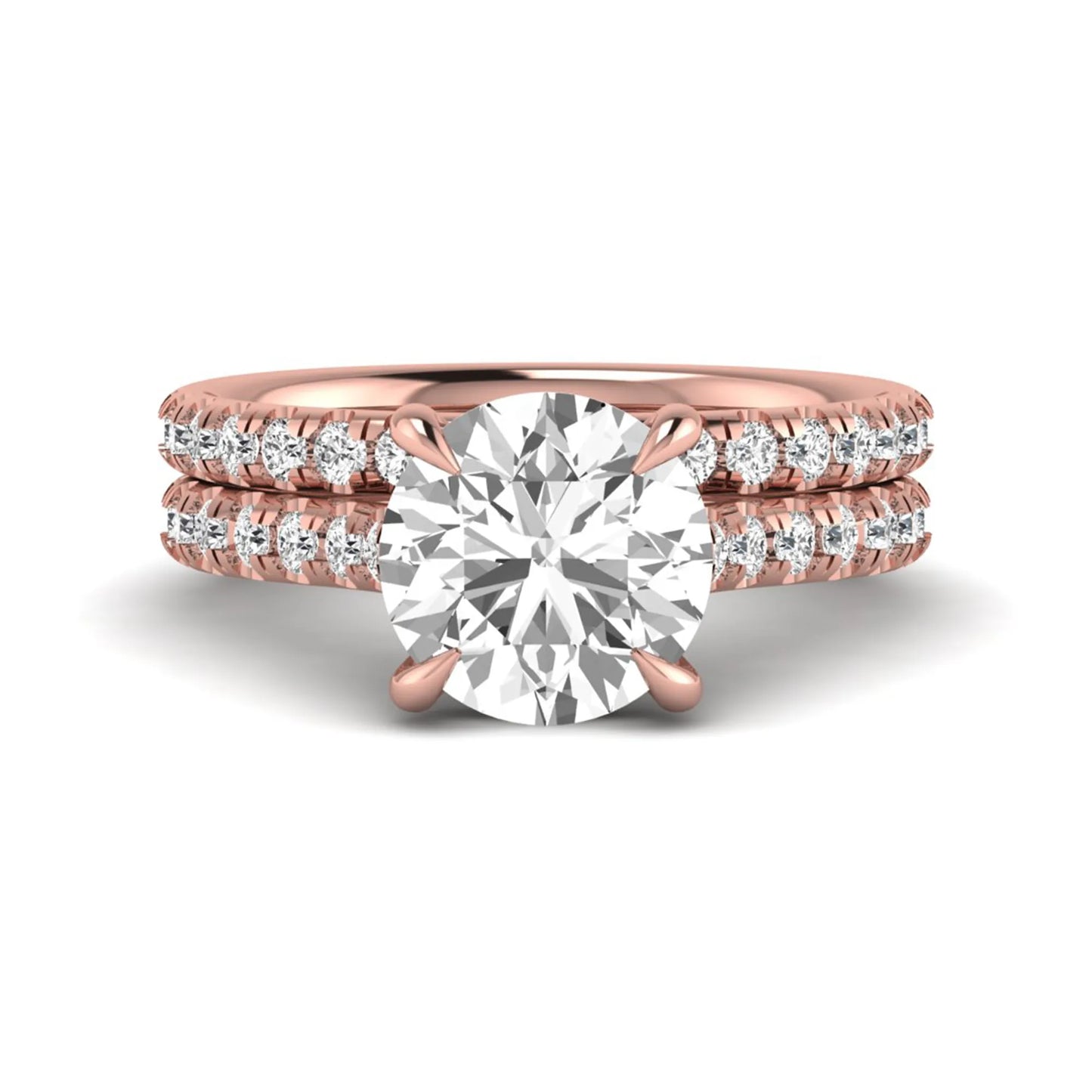 Round cut lab grown diamond bridal ring set featuring a four-prong solitaire center diamond with pavé-set engagement ring and matching pavé wedding band in a rose gold finish.