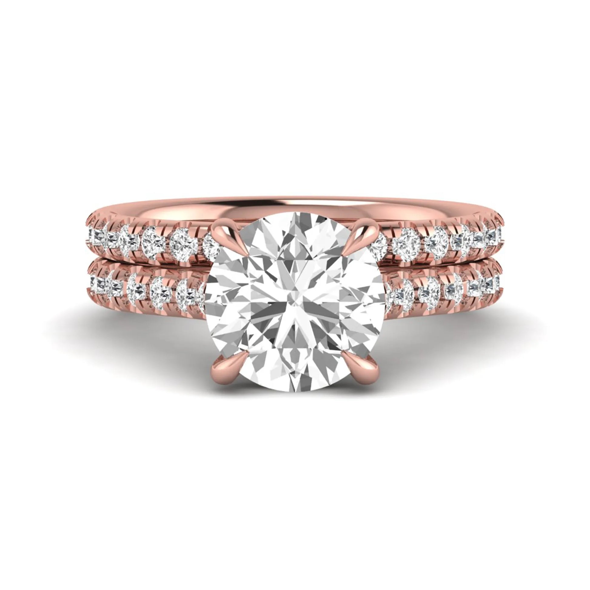 Round cut lab grown diamond bridal ring set featuring a four-prong solitaire center diamond with pavé-set engagement ring and matching pavé wedding band in a rose gold finish.