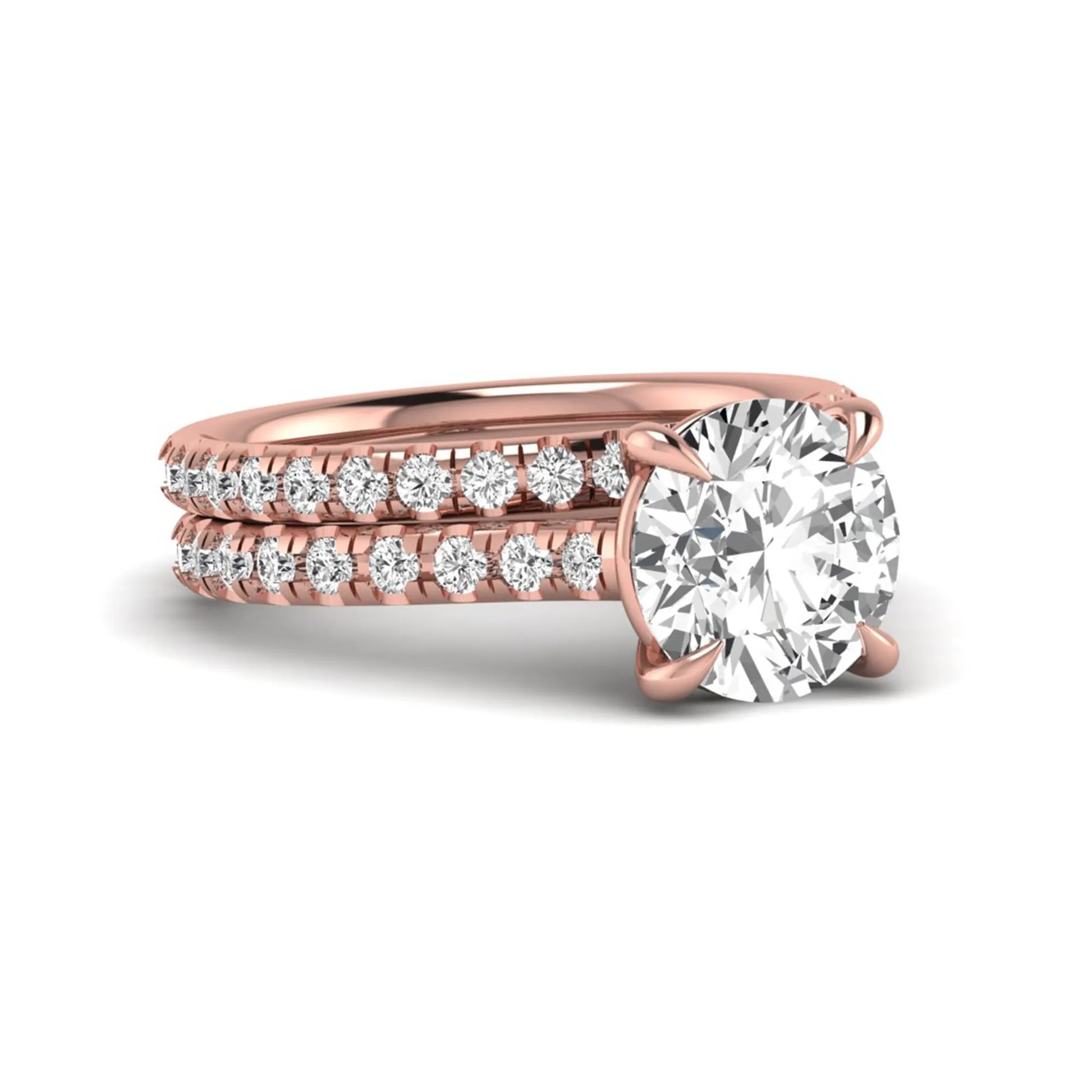 Round cut lab grown diamond bridal ring set featuring a four-prong solitaire center diamond with pavé-set engagement ring and matching pavé wedding band in a rose gold finish.