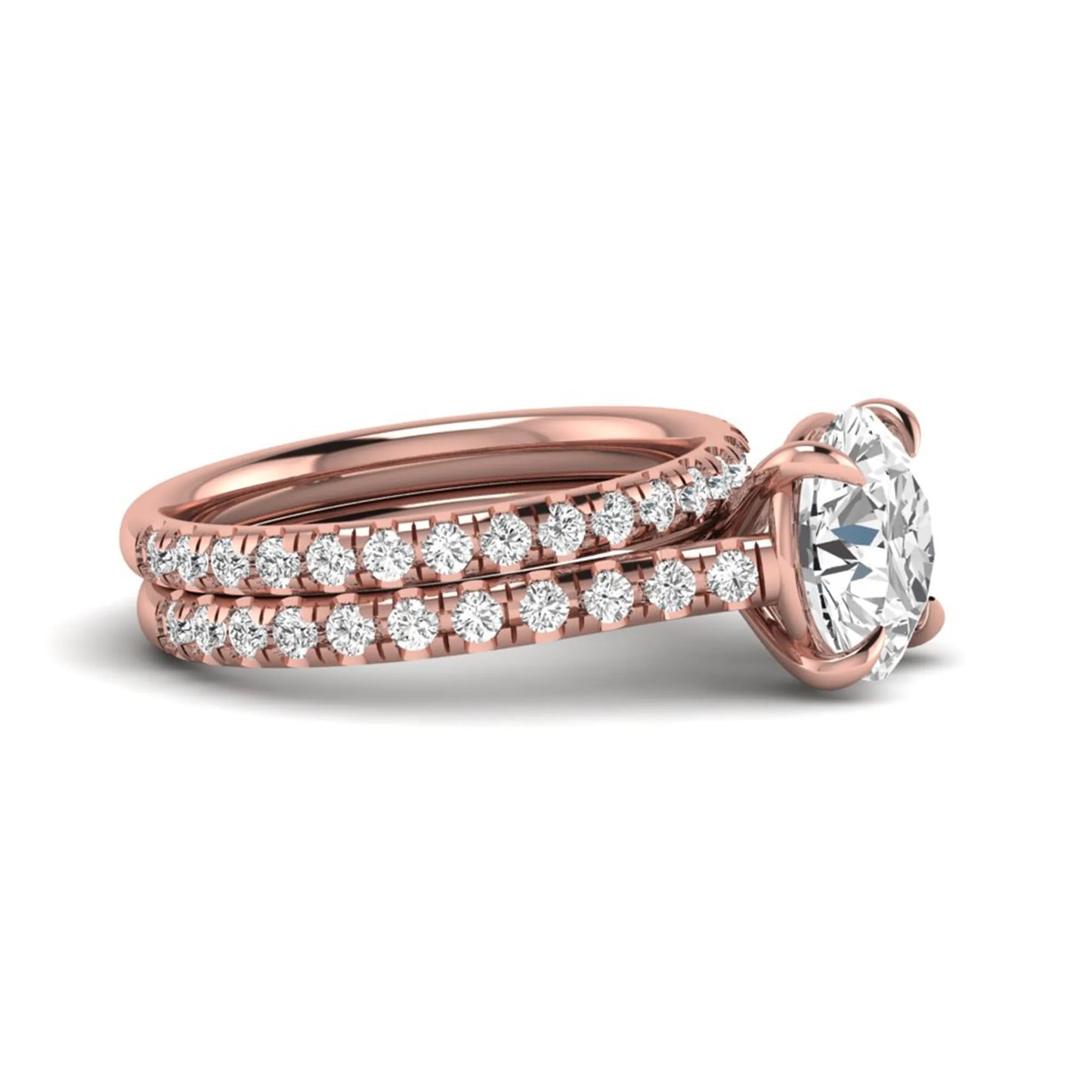 Round cut lab grown diamond bridal ring set featuring a four-prong solitaire center diamond with pavé-set engagement ring and matching pavé wedding band in a rose gold finish.