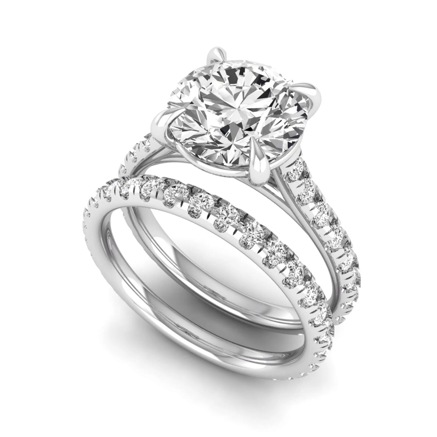 Round cut lab grown diamond bridal ring set featuring a four-prong solitaire center diamond with pavé-set engagement ring and matching pavé wedding band in a white gold finish.
