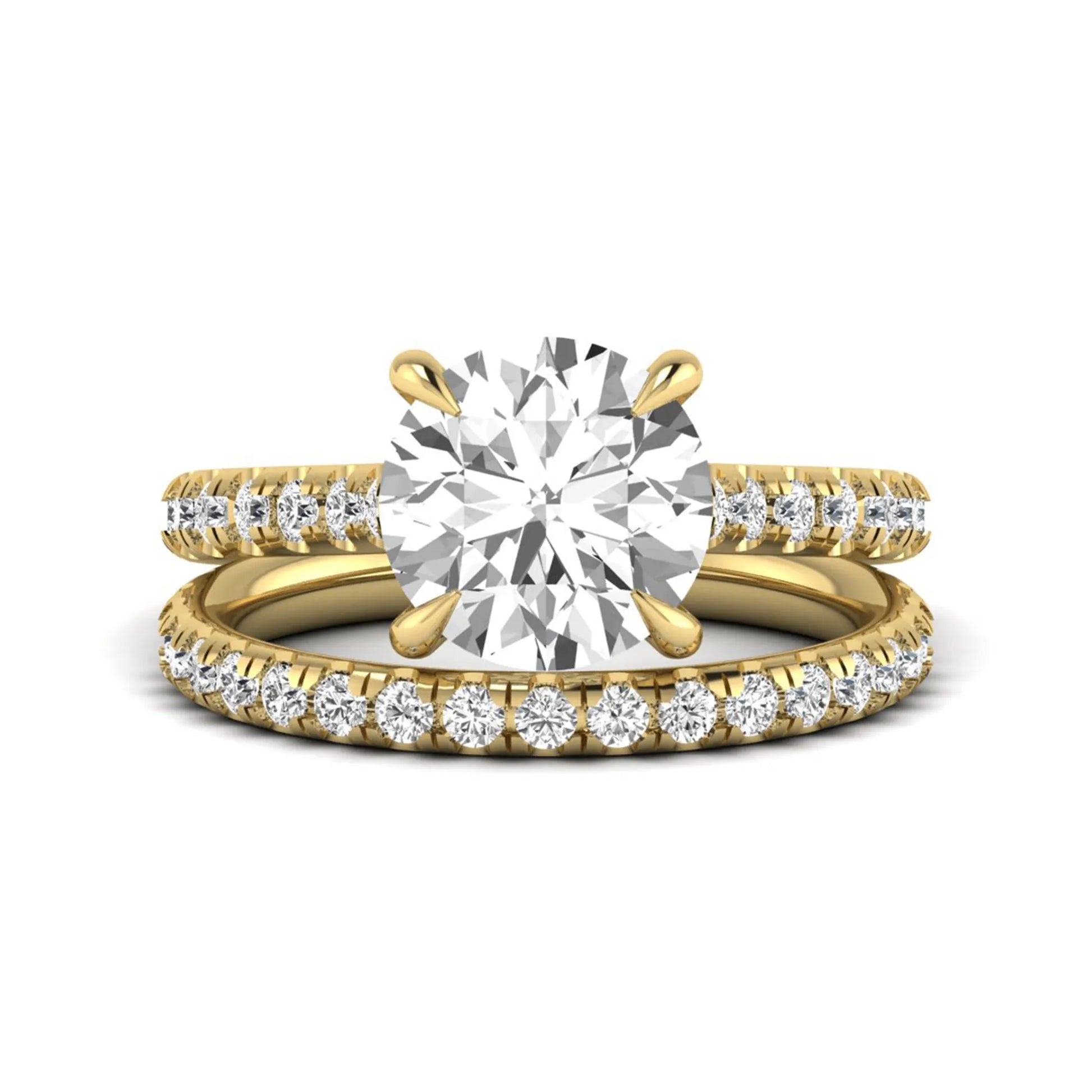 Round cut lab grown diamond bridal ring set featuring a four-prong solitaire center diamond with pavé-set engagement ring and matching pavé wedding band in a yellow gold finish.