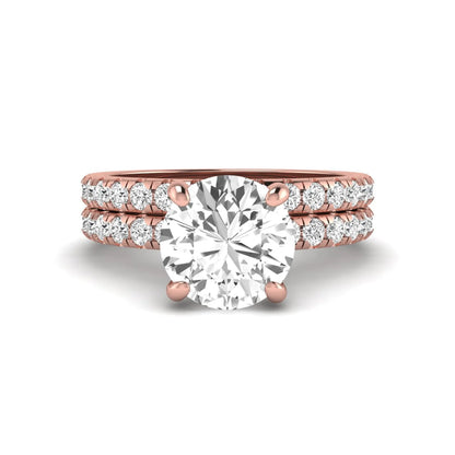Round cut lab grown diamond solitaire bridal ring set featuring pavé diamond bands in a rose gold tone design.