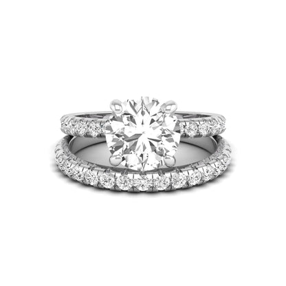 Round cut lab grown diamond solitaire bridal ring set featuring pavé diamond bands in a white gold tone design.