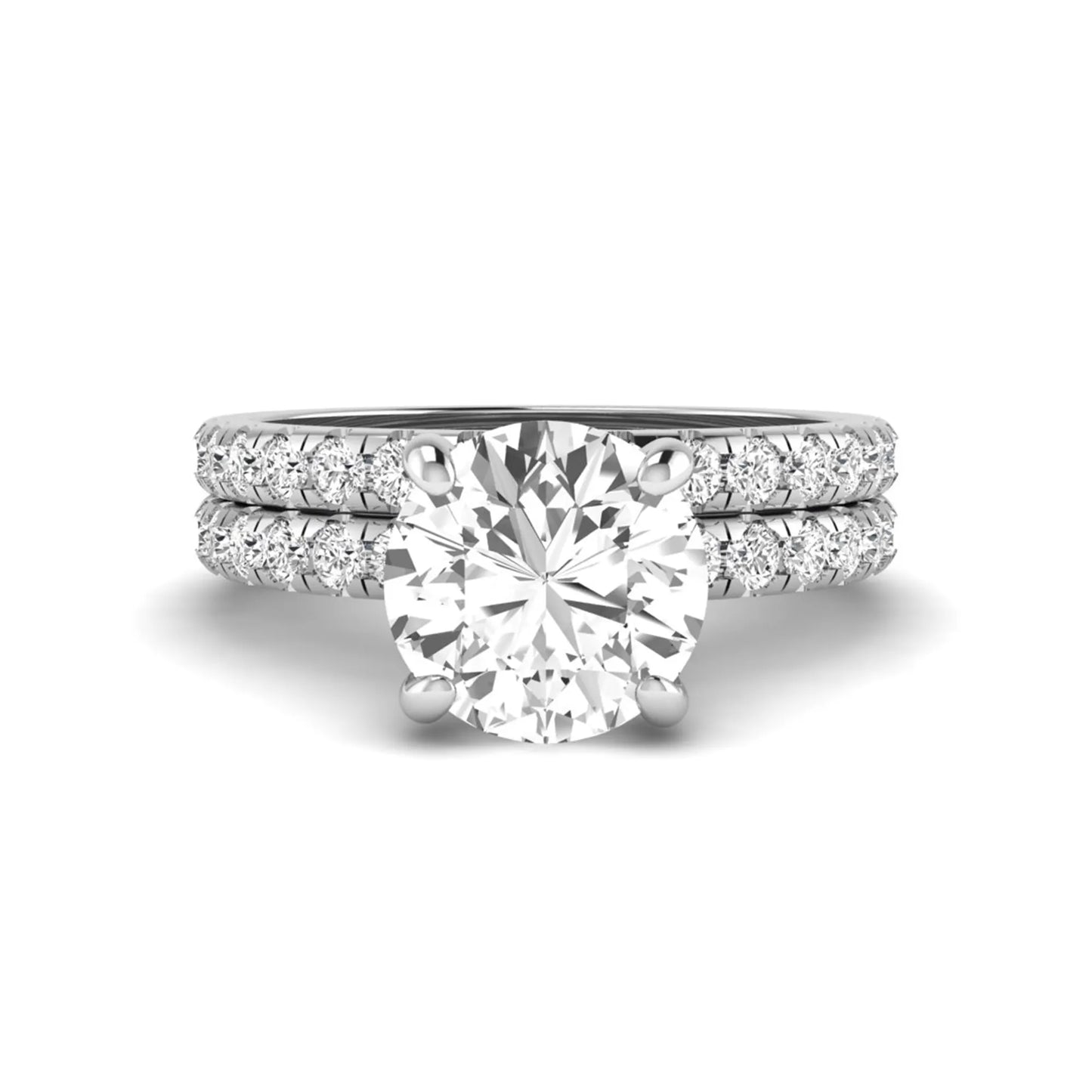 Round cut lab grown diamond solitaire bridal ring set featuring pavé diamond bands in a white gold tone design.