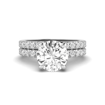 Round cut lab grown diamond solitaire bridal ring set featuring pavé diamond bands in a white gold tone design.
