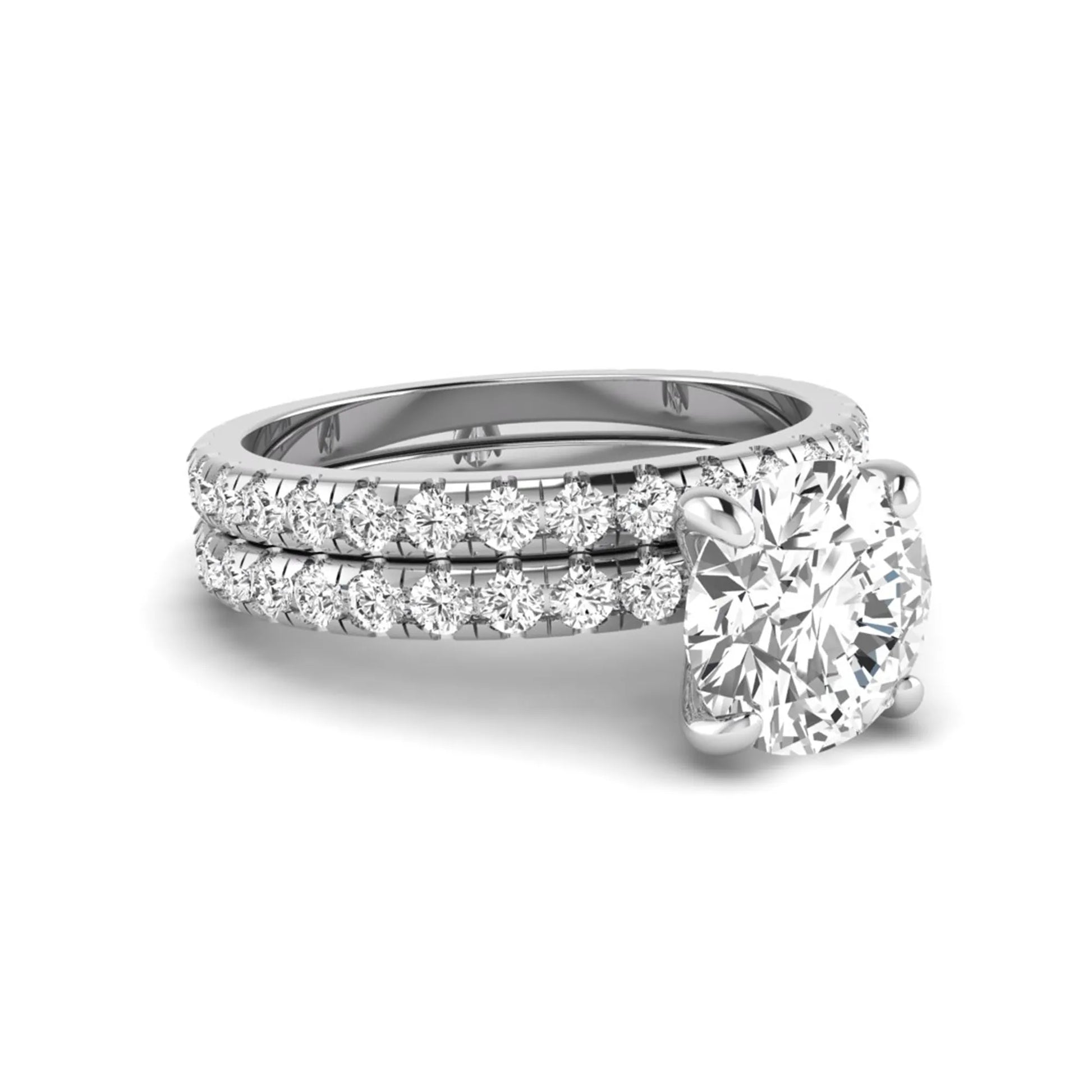 Round cut lab grown diamond solitaire bridal ring set featuring pavé diamond bands in a white gold tone design.
