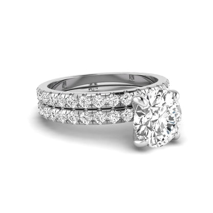 Round cut lab grown diamond solitaire bridal ring set featuring pavé diamond bands in a white gold tone design.