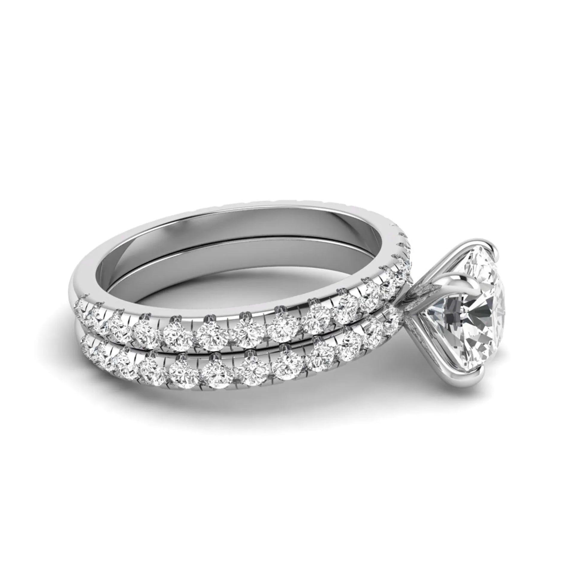 Round cut lab grown diamond solitaire bridal ring set featuring pavé diamond bands in a white gold tone design.