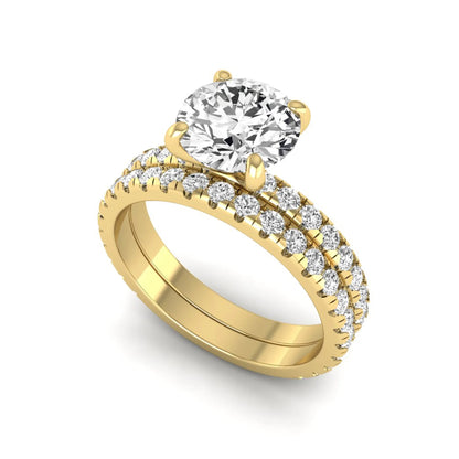 Round cut lab grown diamond solitaire bridal ring set featuring pavé diamond bands in a yellow gold tone design.