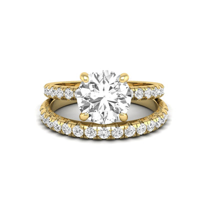 Round cut lab grown diamond solitaire bridal ring set featuring pavé diamond bands in a yellow gold tone design.