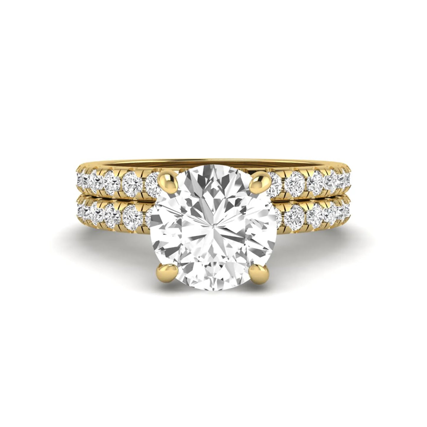 Round cut lab grown diamond solitaire bridal ring set featuring pavé diamond bands in a yellow gold tone design.