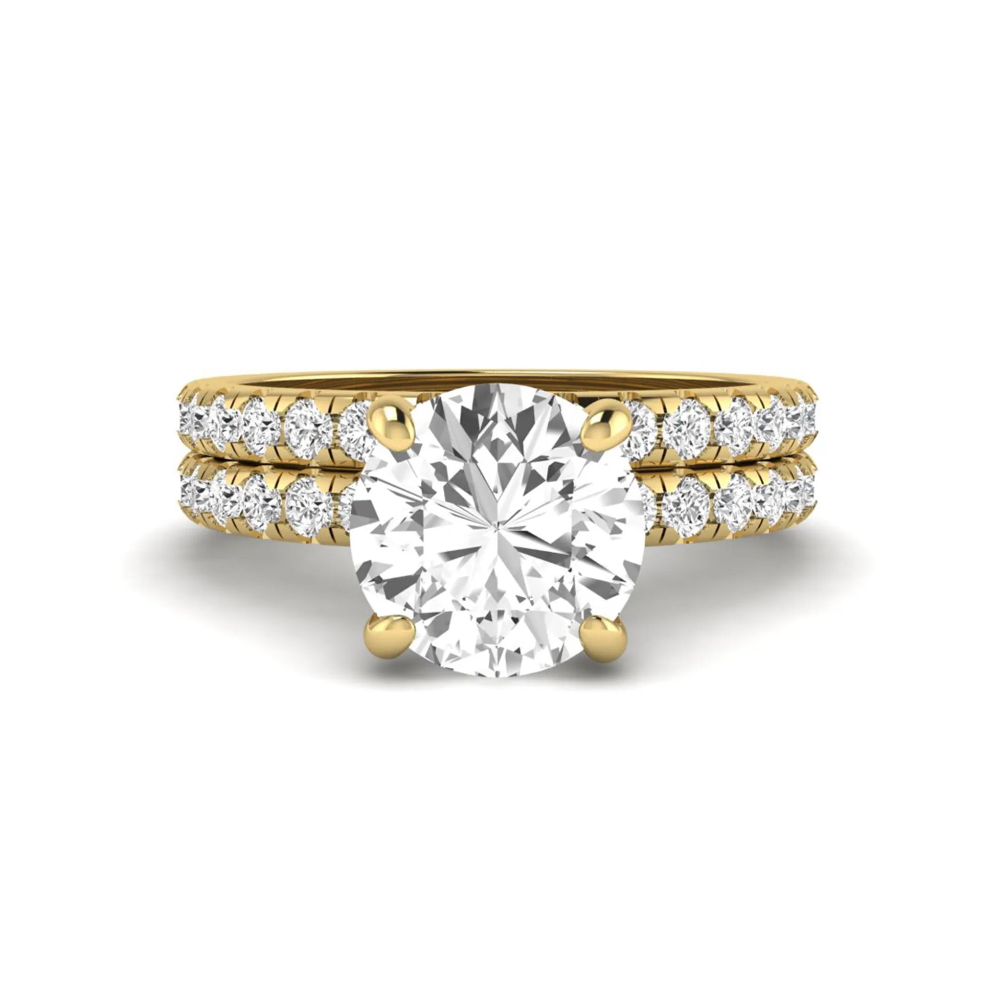 Round cut lab grown diamond solitaire bridal ring set featuring pavé diamond bands in a yellow gold tone design.