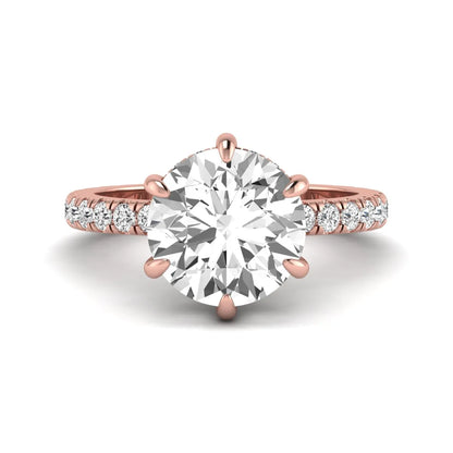 Round cut lab grown diamond solitaire engagement ring with pavé diamond band in rose gold design.