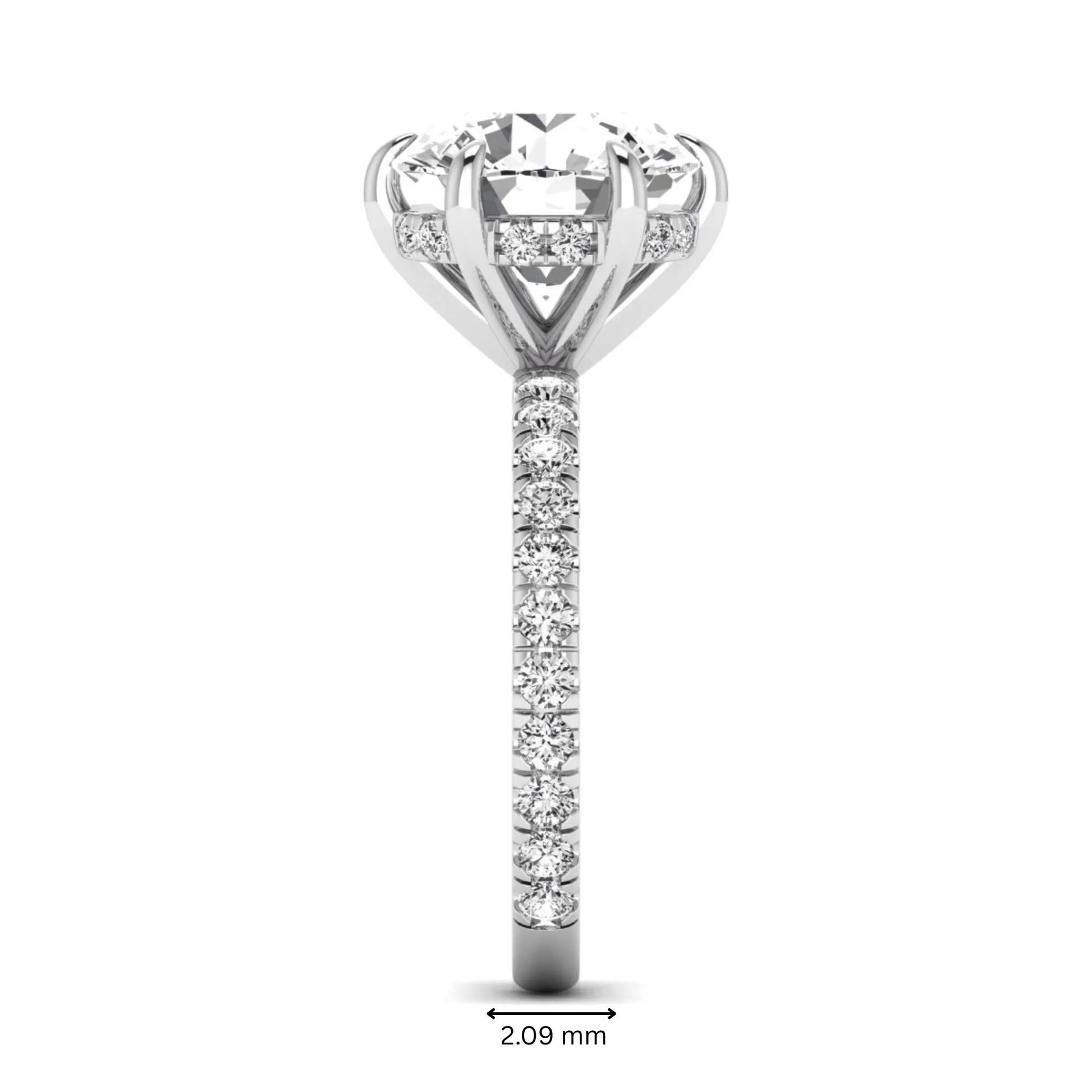 Round cut lab grown diamond solitaire engagement ring with pavé diamond band in white gold design.