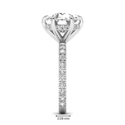 Round cut lab grown diamond solitaire engagement ring with pavé diamond band in white gold design.