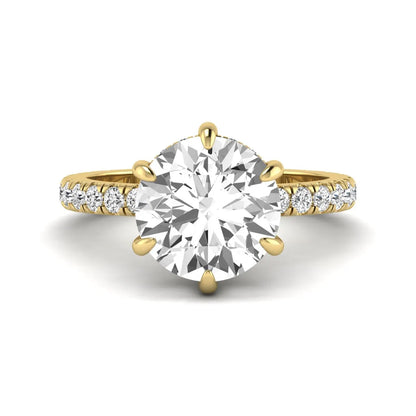 Round cut lab grown diamond solitaire engagement ring with pavé diamond band in yellow gold design.