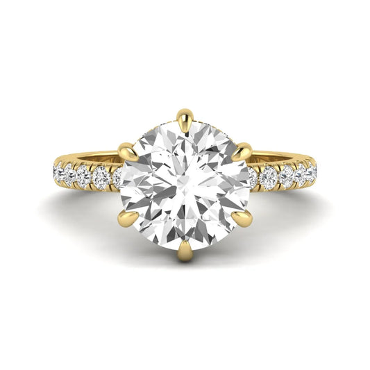 Round cut lab grown diamond solitaire engagement ring with pavé diamond band in yellow gold design.