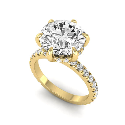 Round cut lab grown diamond solitaire engagement ring with pavé diamond band in yellow gold design.