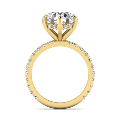 Round cut lab grown diamond solitaire engagement ring with pavé diamond band in yellow gold design.