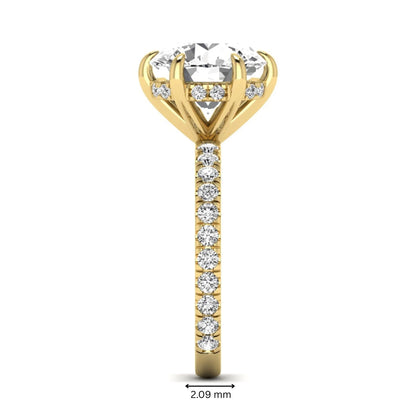 Round cut lab grown diamond solitaire engagement ring with pavé diamond band in yellow gold design.