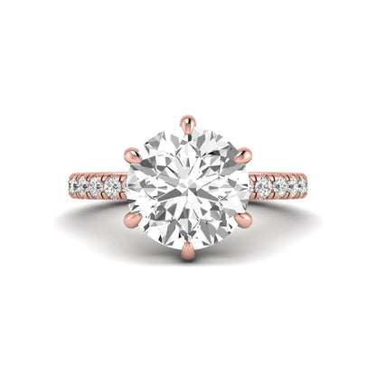 Round cut lab grown diamond solitaire engagement ring with pavé diamond band in rose gold design.